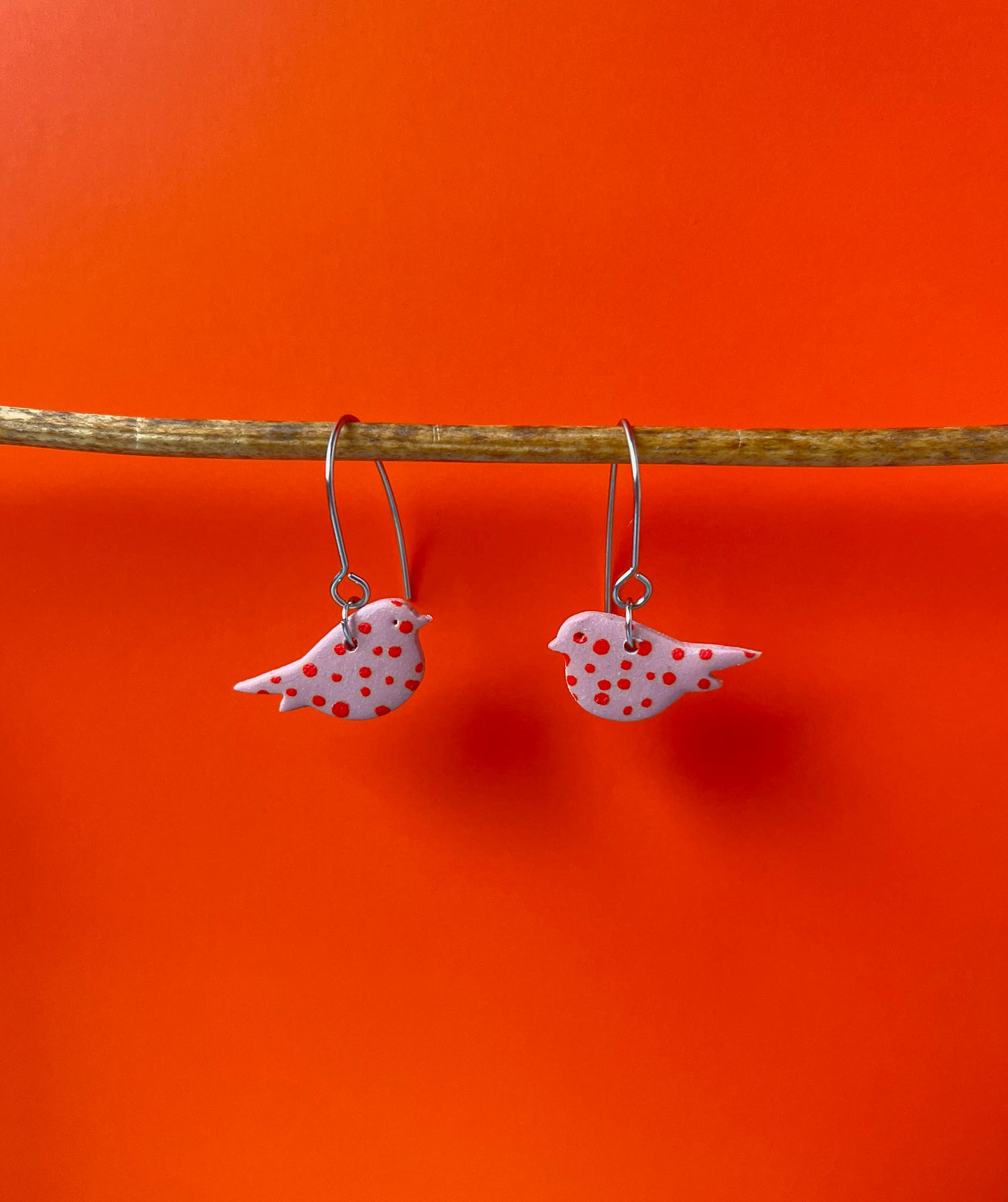Pink and orange polka dot bird earrings